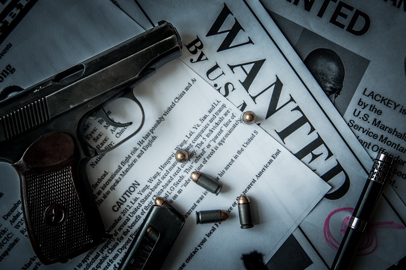 Ads on tracing criminals on the table of the bounty hunter, combat pistol, cartridges